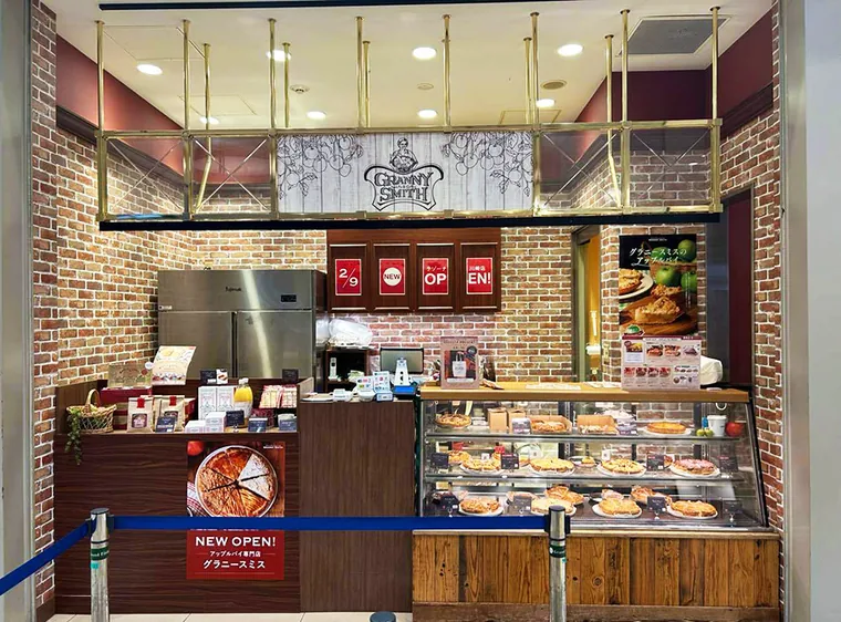 GRANNY SMITH APPLE PIE & COFFEE ラゾーナ川崎店（川崎市・アップルパイ販売店）。木とレンガの意匠、商品ショーケースを組み合わせた販売カウンター。